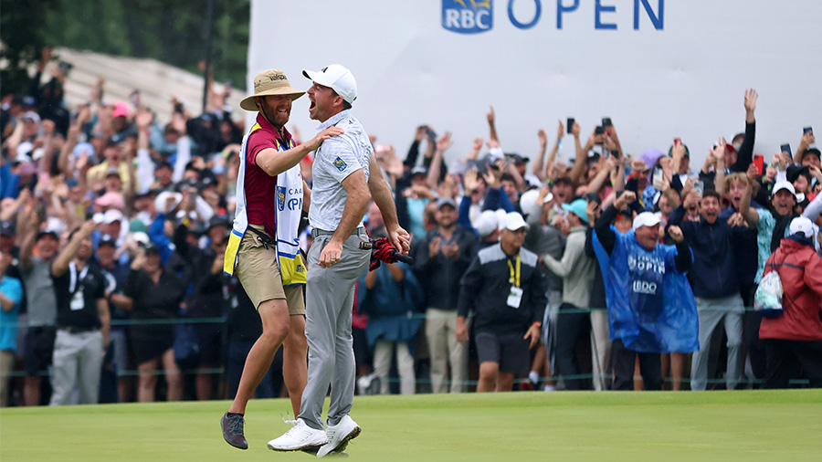 Nick Taylor of Canada celebrates with his caddy after making an eagle putt on the 4th playoff hole ...